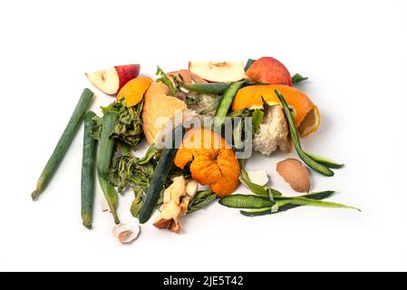 Organic waste ready to recycle, isolated on white background. Organic leftovers, kitchem scraps, waste from vegetable ready for recycling and to compo Stock Photo