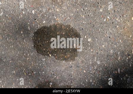 a highway with oil stains on the surface, a polluted highway from engine oil leaked from broken cars Stock Photo