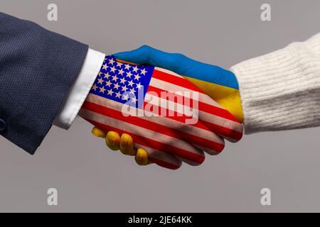 USA and Ukraine flag, handshake closeup on grey background Stock Photo