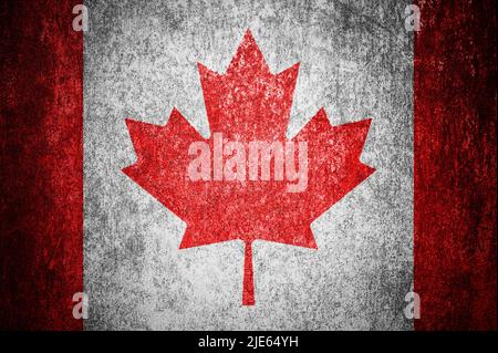 Closeup of grunge Canadian flag. Dirty Canada flag on a metal surface. Stock Photo