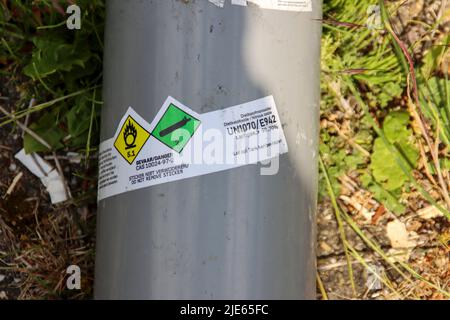 Cylinders with nitrous oxide and black balloons left in parking lot after use as drugs in The Hague Stock Photo