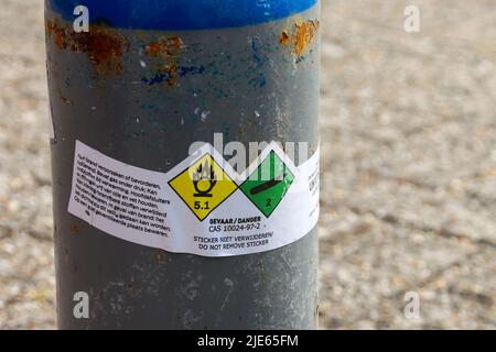 Cylinders with nitrous oxide and black balloons left in parking lot after use as drugs in The Hague Stock Photo