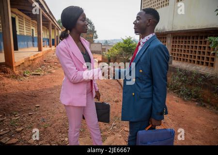 Two african business people shake hands, are smartly dressed, business colleagues in agreement Stock Photo