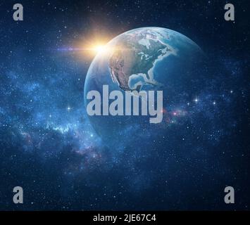 Planet Earth, viewed from space focusing on North America, USA. Earth globe in deep space, stars shining and sun rising on the horizon. Stock Photo