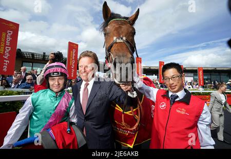 Jockey Colin Keane (left) and trainer Ralph Beckett celebrate after winning the Dubai Duty Free Irish Derby with horse Westover during day two of the Dubai Duty Free Irish Derby Festival at Curragh Racecourse in County Kildare, Ireland. Picture date: Saturday June 25, 2022. Stock Photo