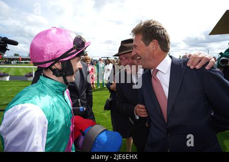 Jockey Colin Keane (left) and trainer Ralph Beckett (right) celebrate after winning the Dubai Duty Free Irish Derby with horse Westover during day two of the Dubai Duty Free Irish Derby Festival at Curragh Racecourse in County Kildare, Ireland. Picture date: Saturday June 25, 2022. Stock Photo