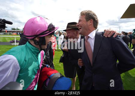 Jockey Colin Keane (left) and trainer Ralph Beckett (right) celebrate after winning the Dubai Duty Free Irish Derby with horse Westover during day two of the Dubai Duty Free Irish Derby Festival at Curragh Racecourse in County Kildare, Ireland. Picture date: Saturday June 25, 2022. Stock Photo