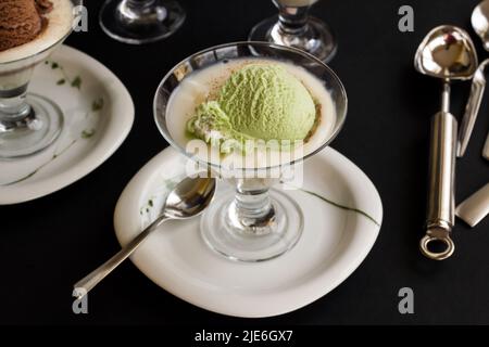 Traditional Turkish Dessert, Rice Pudding, served with a spoonful of pistachio ice cream. Stock Photo