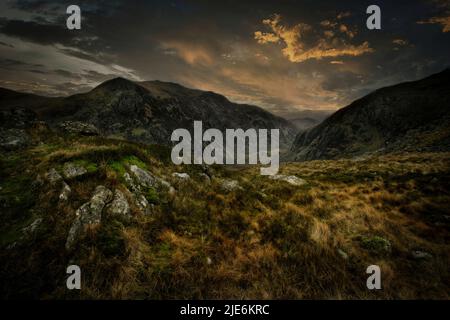 Sunset on the mountain range of Snowdonia National Park Wales. Stock Photo