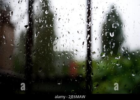 raindrops on the window pane, with blurred background Stock Photo