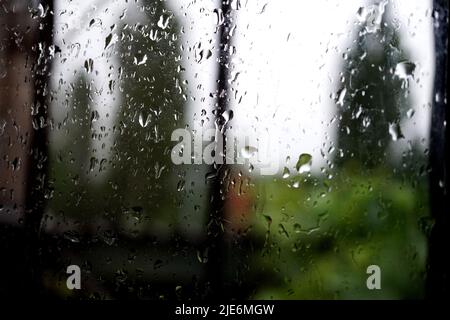 raindrops on the window pane, with blurred background Stock Photo