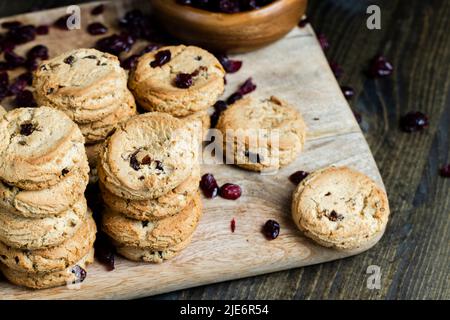 round wheat cookies with dried cranberries, delicious dried cookies made of high-quality flour with dried red cranberries on the table