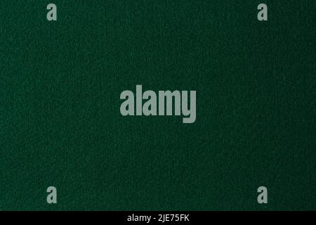 Green color felt textile fabric material texture background. Abstract monochrome dark blue color felt background Stock Photo