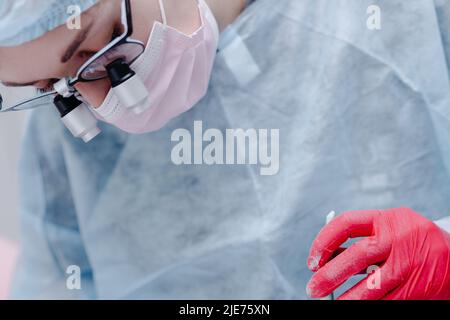 Woman dentist at work. Dentist shark with microscope close up. High quality photo Stock Photo