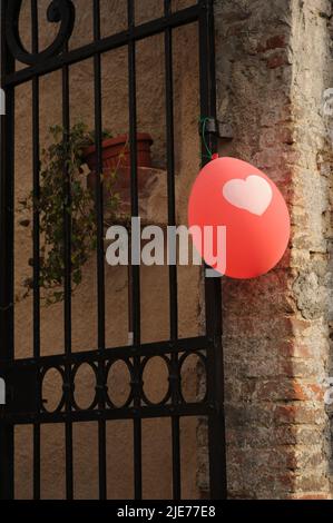 Red balloon with a heart shaped patter Stock Photo