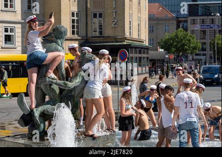 Students in a fountain celebrating graduating from high school in Aarhus, Denmark on 25 June 2022 Stock Photo