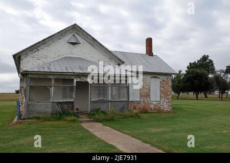 A boarded-up brick building at Fort Reno, west of El Reno, Oklahoma. The historic former army fort off Route 66 dates to 1874. Stock Photo