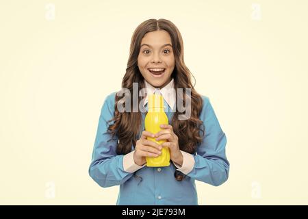 Happy child hold yellow plastic bottle with delicious refreshing beverage, pleasure Stock Photo