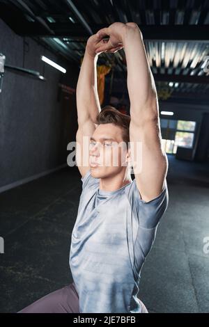 Sportsman doing shoulder stretch during fitness workout Stock Photo