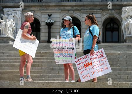 Harrisburg, United States. 25th June, 2022. Abortion rights advocate Cate Tershak (left) speaks with anti-abortion demonstrators Elizabeth McNulty (center) and Mary Krolicki (right), both from Students for Life of America, as they hold a rally on the steps of the Pennsylvania State Capitol. The rally was held in response to the United States Supreme Court ruling in Dobbs v Jackson Women's Health Organization which overturned the constitutional right to abortion. Credit: SOPA Images Limited/Alamy Live News