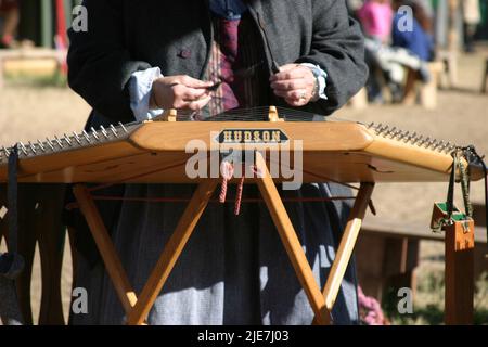 Woman playing Hudson hammered dulcimer