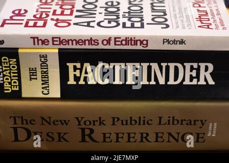 Side view of a pile of knowledgeable books on a table Stock Photo