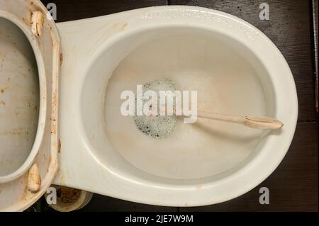 washing a very dirty toilet, messy toilet, very bad condition Stock Photo
