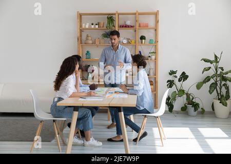 Diverse team take part in group meeting in boardroom Stock Photo