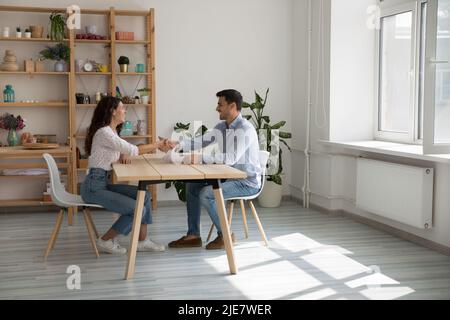 Businesspeople shake hands during meeting in office Stock Photo