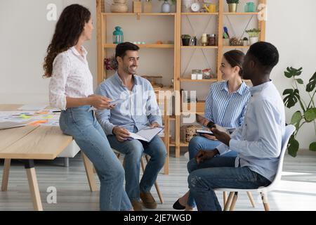 Multinational staff discuss project, share creative ideas during group meeting Stock Photo