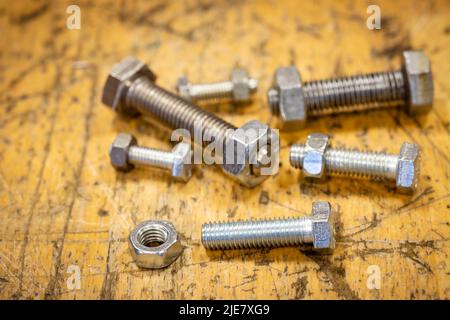 set of screws of different sizes on a wooden workbench Stock Photo