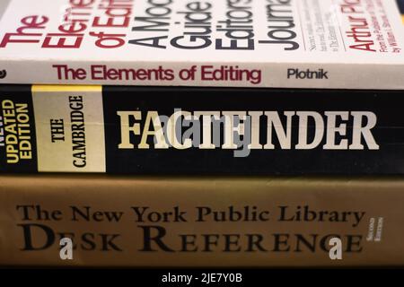 Side view of a pile of knowledgeable books on a table Stock Photo