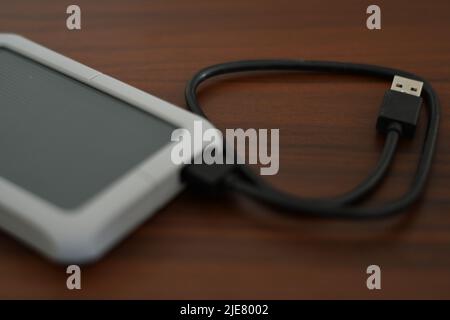 Portable HDD with its cable on a table Stock Photo