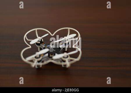 Tiny quadcopter on a wooden table Stock Photo