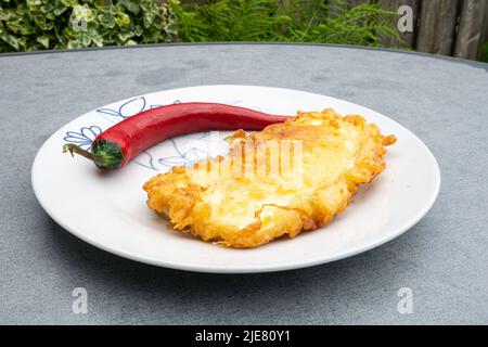 Plate with red hot chili pepper and breaded aubergine, traditional hungarian food Stock Photo