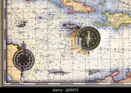 Compass lies on an old map of the Caribbean Sea Stock Photo