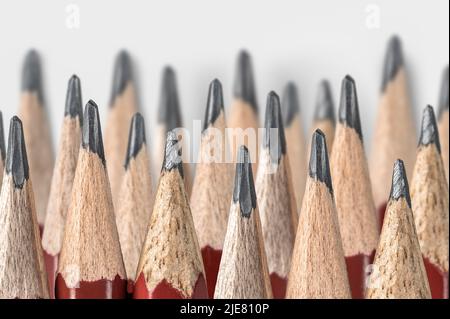 lot of sharpened pencils laid out in several rows. sharpened pencils close up isolated on gray background. tool for drawing, drafting and drawing up p Stock Photo