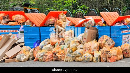 Local council public rubbish & recycling drop off layby close up overflowing bins where waste management resources failed to meet demand England UK Stock Photo