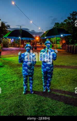 Glastonbury, UK. 25th June, 2022. Performers dressed as a Magritte Painting entertain people in the evening - The 50th 2022 Glastonbury Festival, Worthy Farm. Glastonbury, Credit: Guy Bell/Alamy Live News Stock Photo