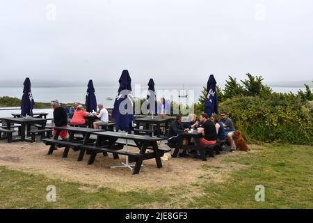 People sitting having a drink outside The Old Point House, Angle, Pembrokeshire, Wales Stock Photo