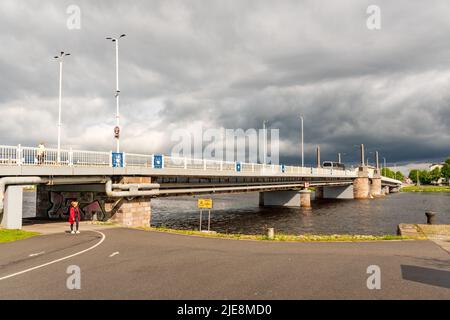 Parnu kesklinna white old bridge on the Parnu river with cloudy sky on background Stock Photo