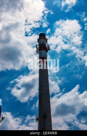 Factory chimney against a cloudy sky. Air pollution from smoke coming out of factory chimneys. The concept of air pollution, environmental problems, a Stock Photo