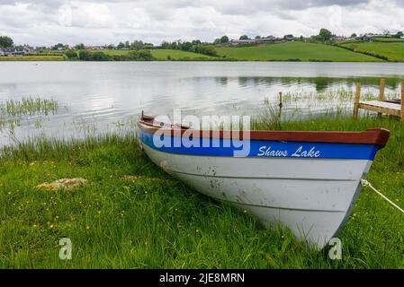 Rowing boat moored up at a lake Stock Photo