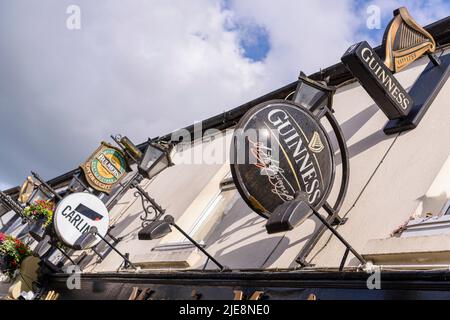 Signs for Guinness, Carling and Bulmers outside an Irish pub. Stock Photo