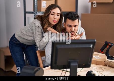 Man and woman ecommerce business workers having video call at office Stock Photo