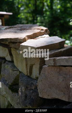 Stack of stones. Stone stack wall in the forest. Stock Photo