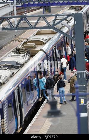 Passengers embarking on a scotrail commuter train at a busy uk railway platform. Stirling, Scotland, Stock Photo