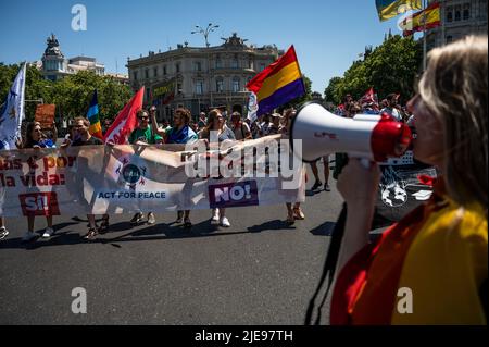 Madrid, Spain. 26th June, 2022. People carrying banners during a demonstration against NATO. Spain will host a NATO Summit in Madrid on 29 and 30th of June 2022. Credit: Marcos del Mazo/Alamy Live News Stock Photo