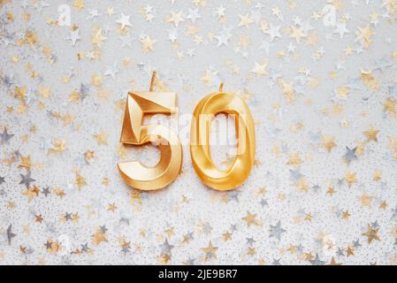 Number 50 fifty golden celebration birthday candle on Festive Background. Ten years birthday. concept of celebrating birthday, anniversary, important date, holiday Stock Photo