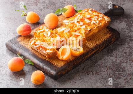 Sweet apricot biscuit with almonds close-up on a wooden board on the table. horizontal Stock Photo